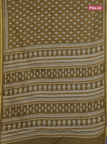 Muslin cotton saree mehendi green with allover dabu prints and zari woven border