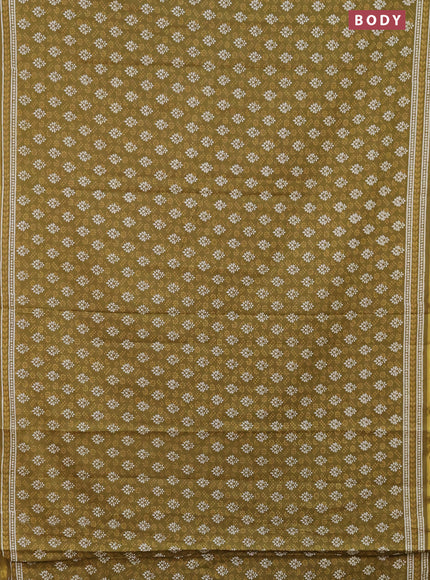 Muslin cotton saree mehendi green with allover prints and zari woven border