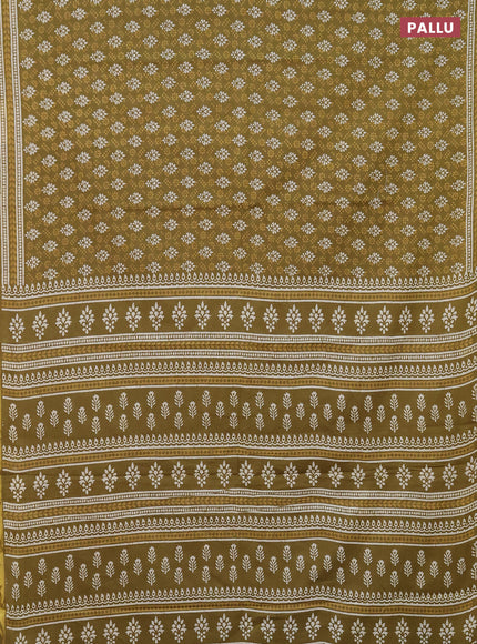 Muslin cotton saree mehendi green with allover prints and zari woven border