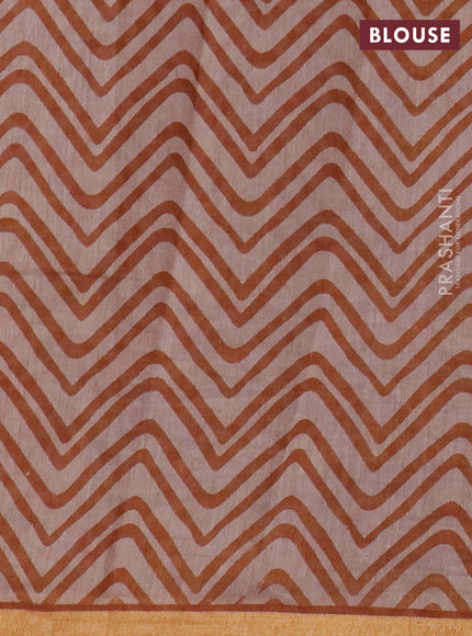 Muslin cotton saree dark mustard with allover prints and zari woven border