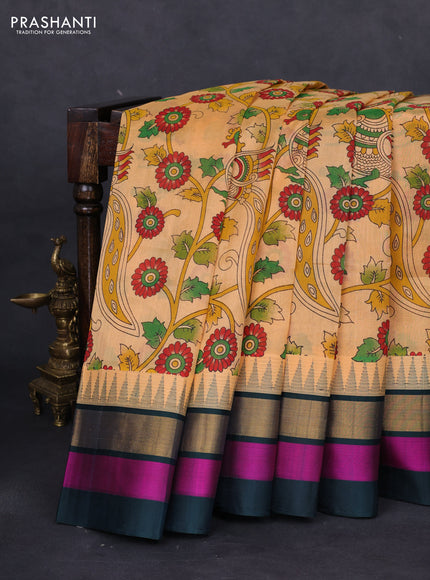 Silk cotton saree pale orange and peacock green with allover kalamkari prints and temple design zari woven simple border