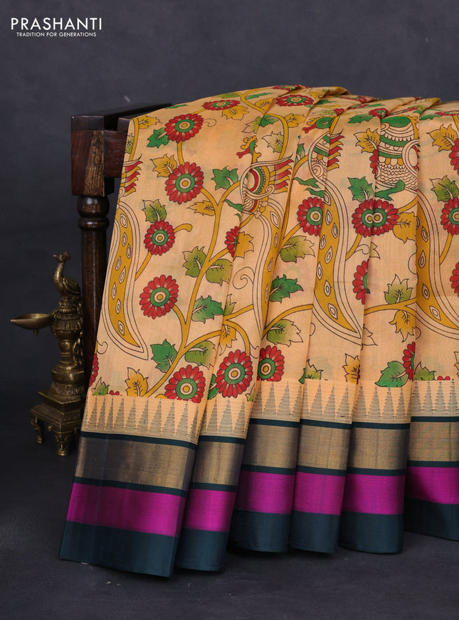 Silk cotton saree pale orange and peacock green with allover kalamkari prints and temple design zari woven simple border