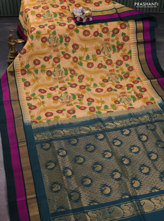 Silk cotton saree pale orange and peacock green with allover kalamkari prints and temple design zari woven simple border