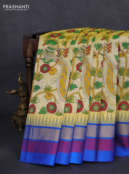 Silk cotton saree pale yellow and cs blue with allover kalamkari prints and temple design zari woven simple border