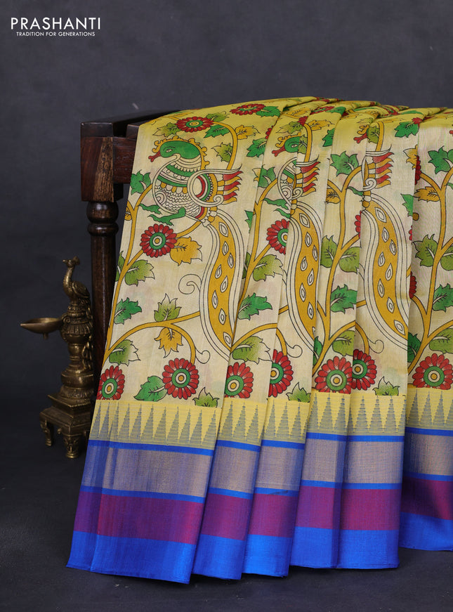 Silk cotton saree pale yellow and cs blue with allover kalamkari prints and temple design zari woven simple border