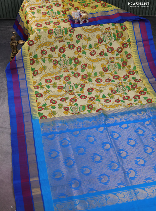 Silk cotton saree pale yellow and cs blue with allover kalamkari prints and temple design zari woven simple border