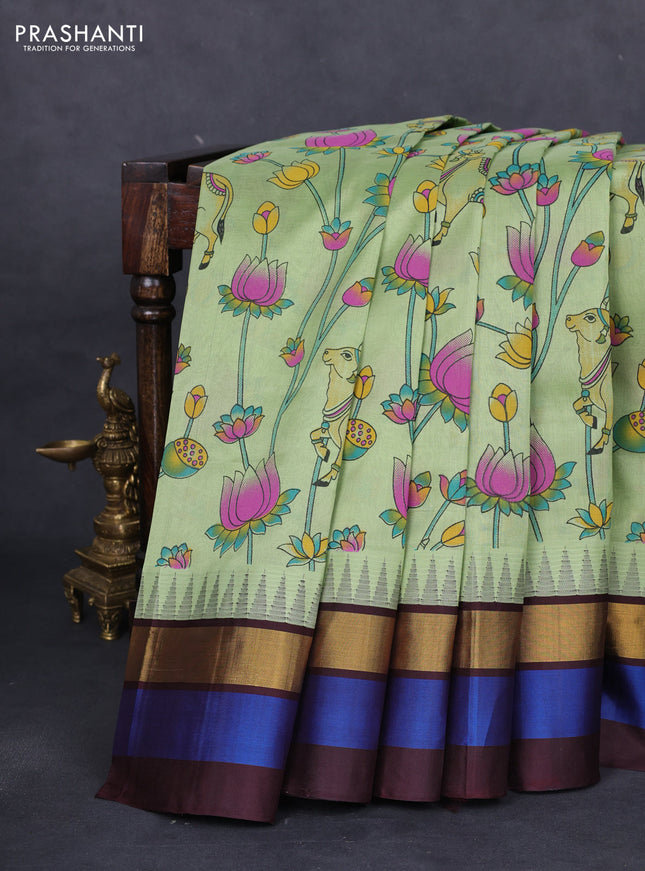 Silk cotton saree pastel green and coffee brown with allover pichwai prints and temple design zari woven simple border