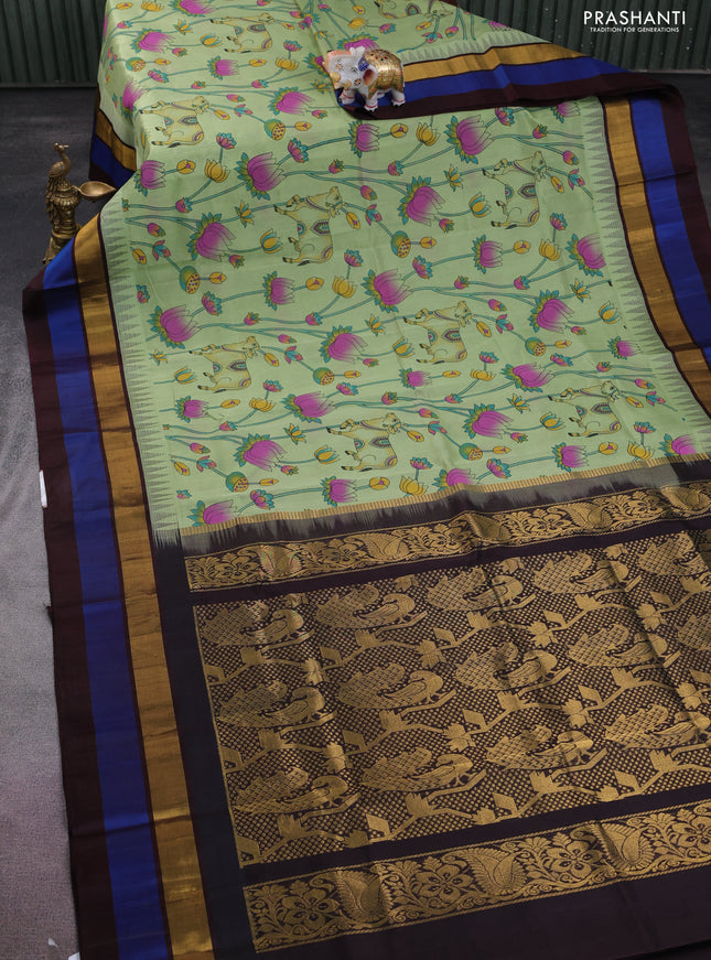 Silk cotton saree pastel green and coffee brown with allover pichwai prints and temple design zari woven simple border