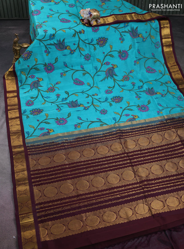Silk cotton saree teal blue and deep maroon with allover kalamkari prints and zari woven korvai border