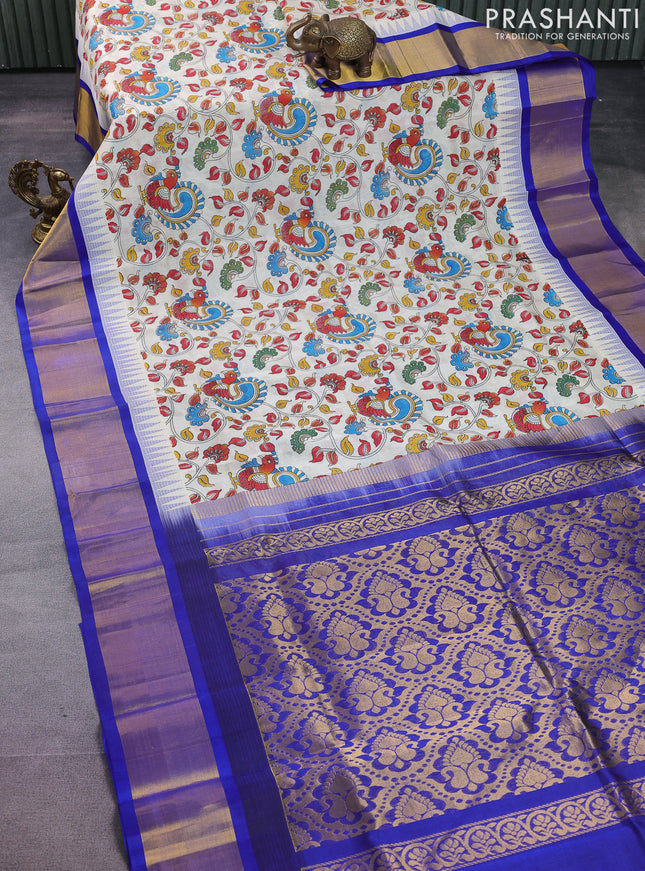 Silk cotton saree cream and blue with allover kalamkari prints and temple design zari woven simple border
