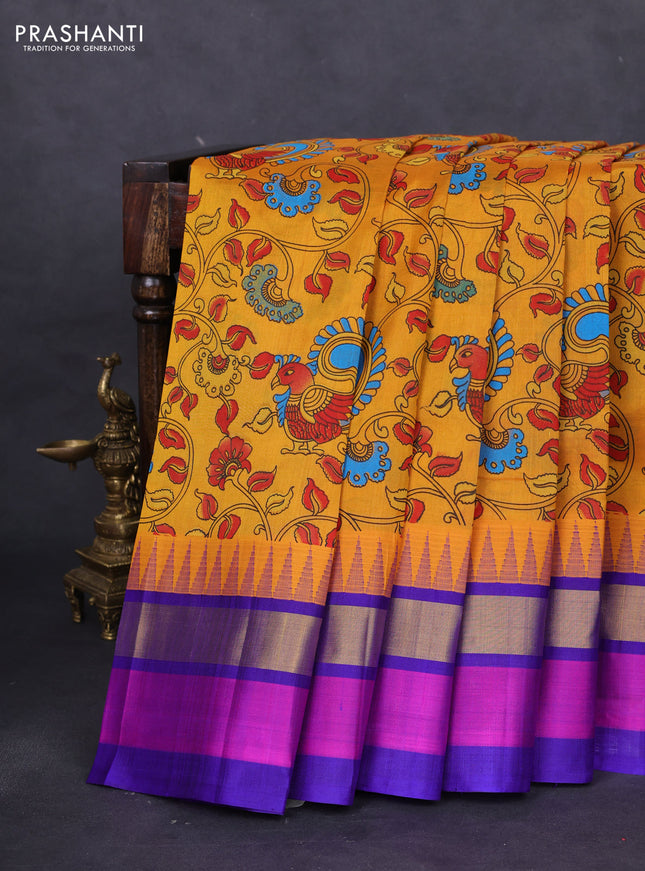 Silk cotton saree mustard yellow and blue with allover kalamkari prints and temple design zari woven simple border