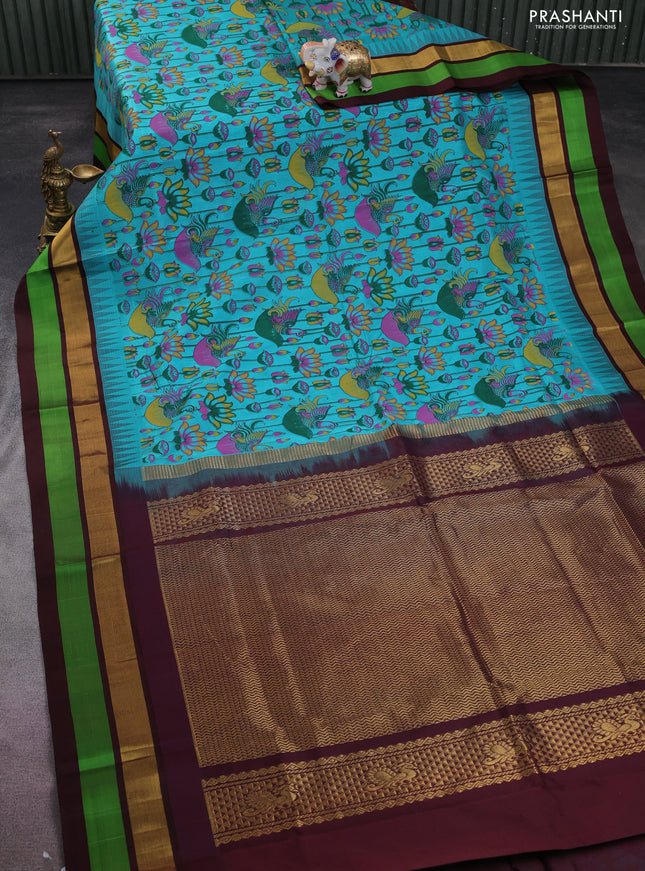 Silk cotton saree teal blue and coffee brown with allover kalamkari prints and temple design zari woven simple border