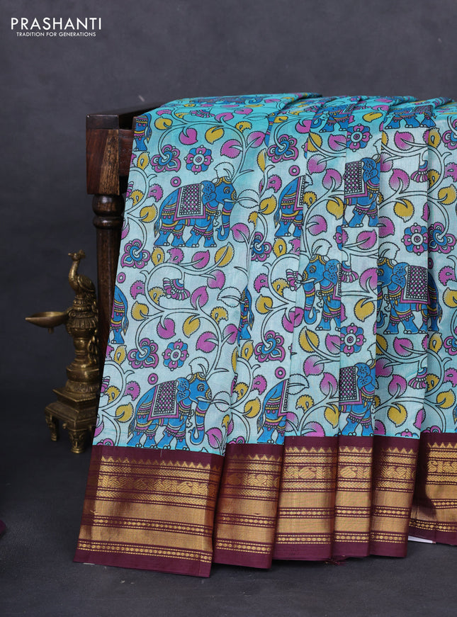 Silk cotton saree teal blue and deep maroon with allover kalamkari prints and zari woven korvai border