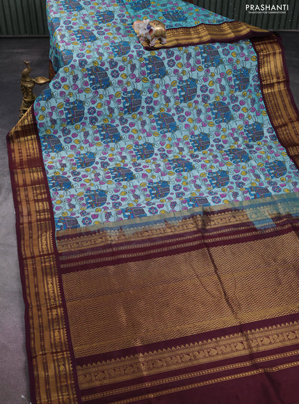 Silk cotton saree teal blue and deep maroon with allover kalamkari prints and zari woven korvai border