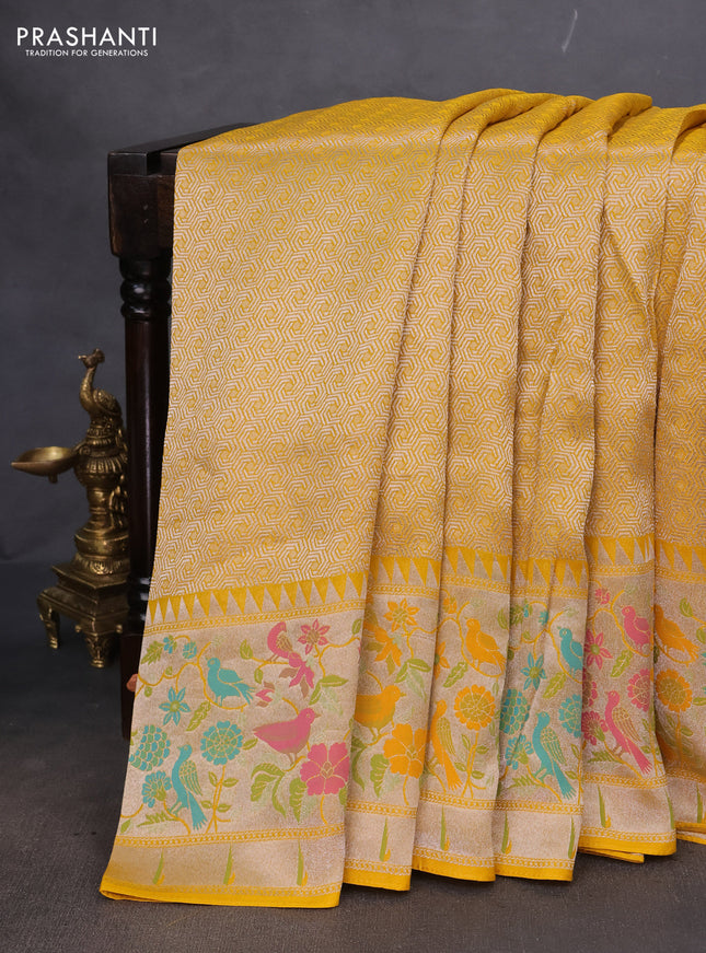 Banarasi semi raw silk saree yellow with allover silver woven brocade weaves and floral design paithani border