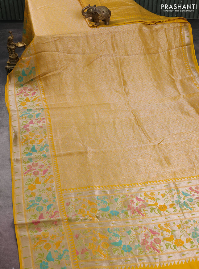 Banarasi semi raw silk saree yellow with allover silver woven brocade weaves and floral design paithani border