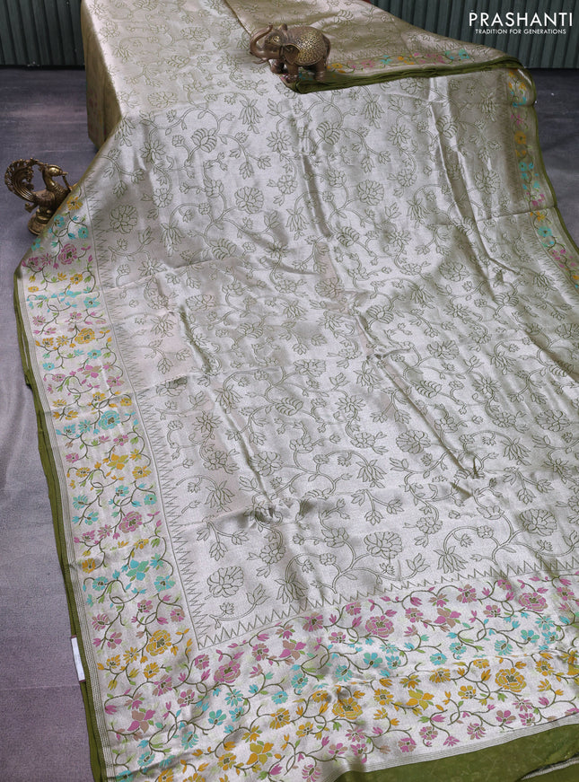 Banarasi semi raw silk saree mehendi green with allover silver zari woven floral weaves and floral design paithani border