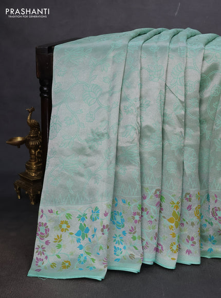 Banarasi semi raw silk saree teal green with allover silver zari woven floral weaves and floral design paithani border