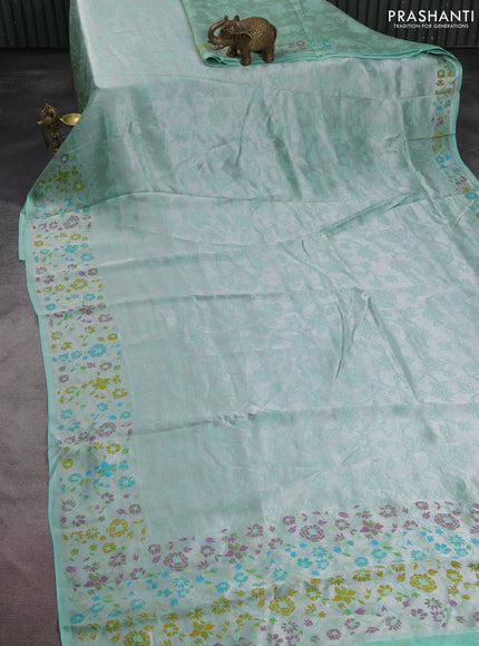 Banarasi semi raw silk saree teal green with allover silver zari woven floral weaves and floral design paithani border