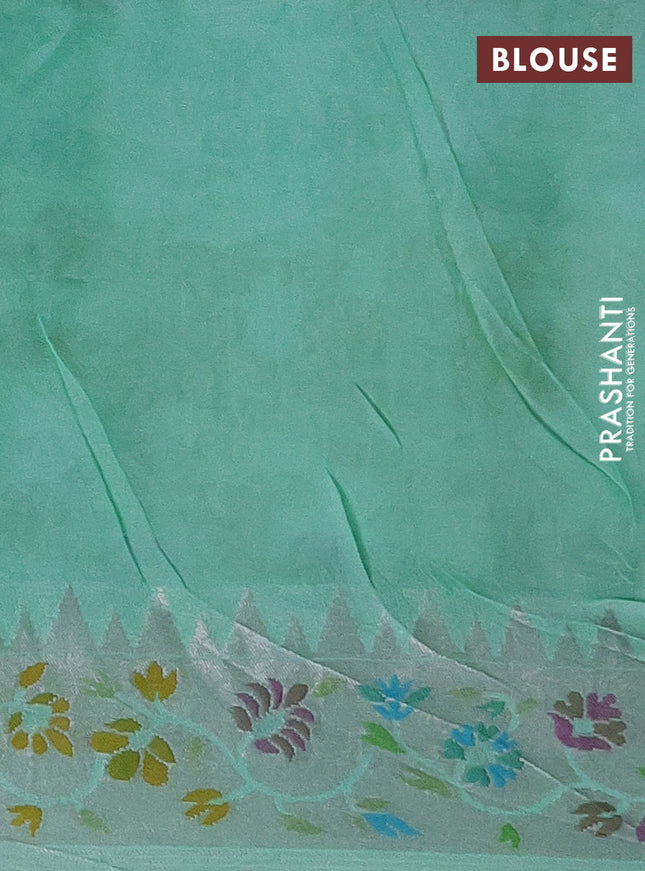 Banarasi semi raw silk saree teal green with allover silver zari woven floral weaves and floral design paithani border