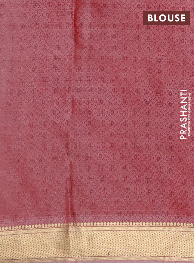 Printed silk saree dual shade of pastel peach with allover prints and zari woven border