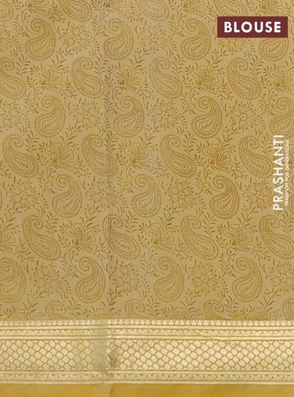 Printed silk saree pale yellow with allover paisley prints and zari woven border