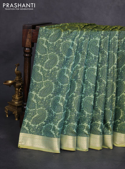 Printed silk saree dual shade of pastel green with allover paisley prints and zari woven border