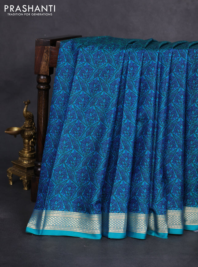 Printed silk saree teal green and blue with allover prints and zari woven border