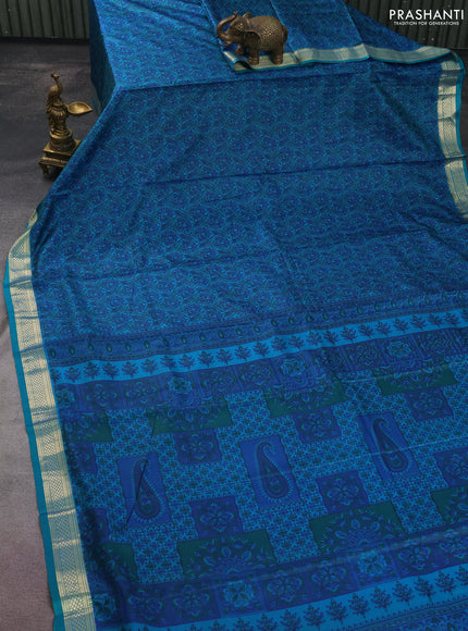 Printed silk saree teal green and blue with allover prints and zari woven border