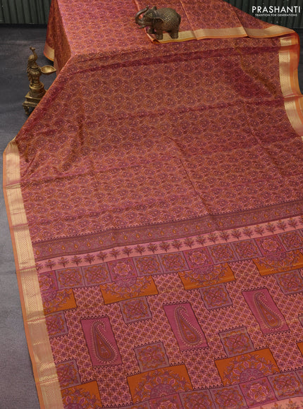 Printed silk saree dual shade of peach orange with allover prints and zari woven border