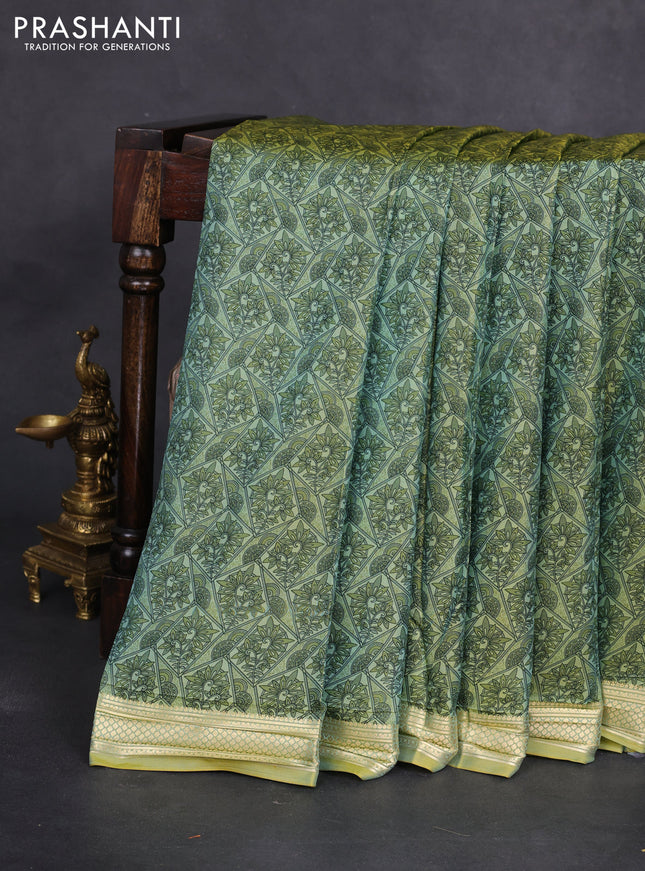 Printed silk saree pastel green with allover prints and zari woven border