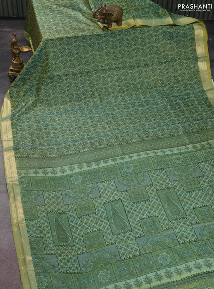 Printed silk saree pastel green with allover prints and zari woven border