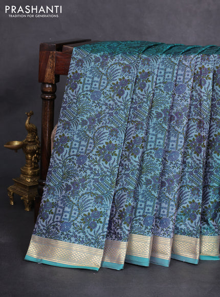 Printed silk saree teal blue with allover prints and zari woven border