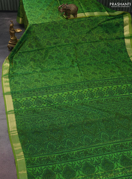 Printed silk saree light green with allover prints and zari woven border