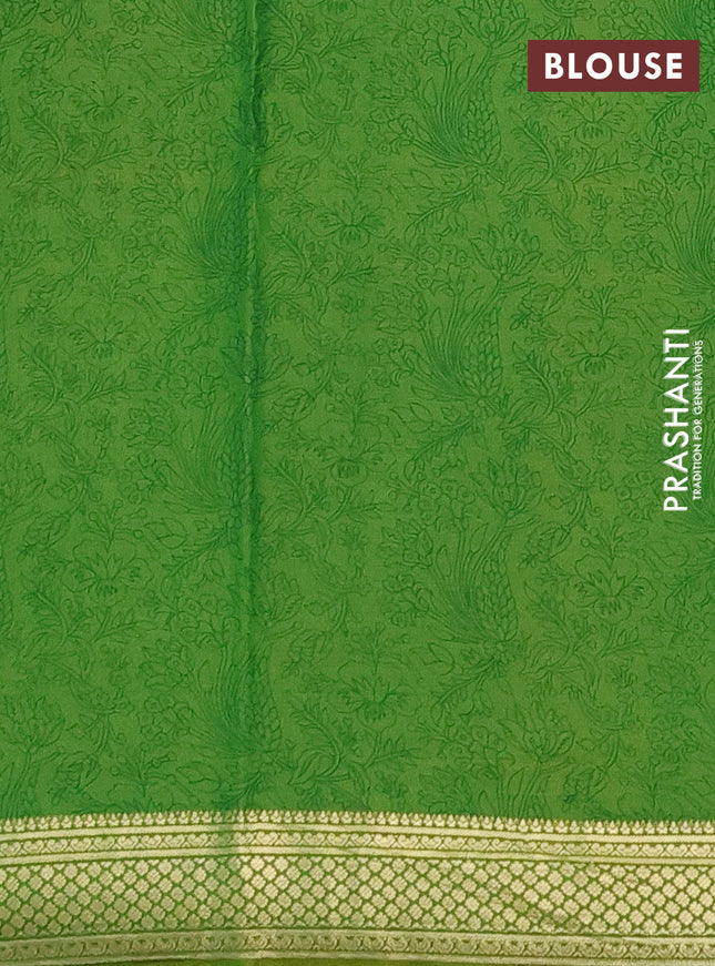 Printed silk saree light green with allover prints and zari woven border