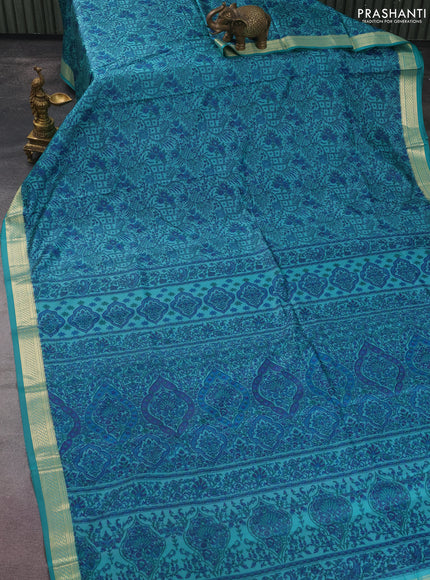 Printed silk saree teal blue with allover prints and zari woven border