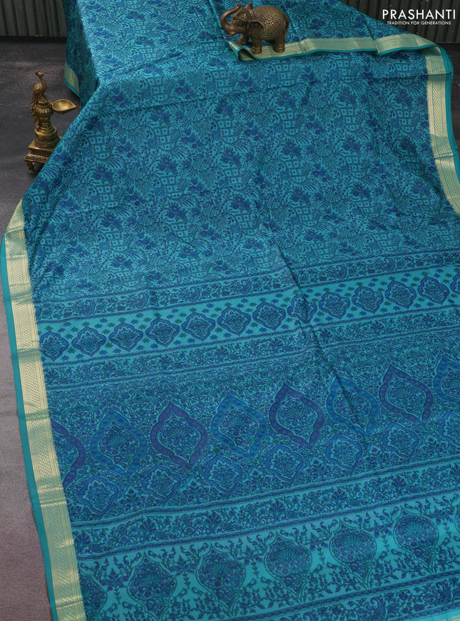 Printed silk saree teal blue with allover prints and zari woven border