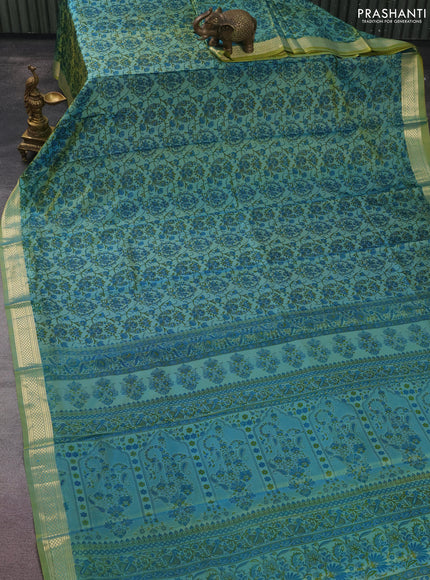 Printed silk saree dual shade of greenish blue with allover prints and zari woven border