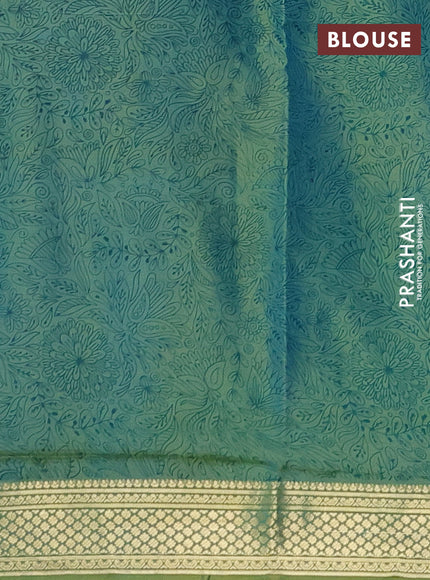 Printed silk saree dual shade of greenish blue with allover prints and zari woven border