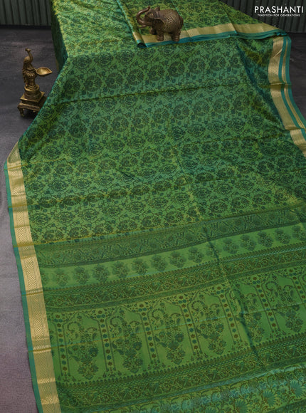 Printed silk saree dual shade of teal green with allover prints and zari woven border