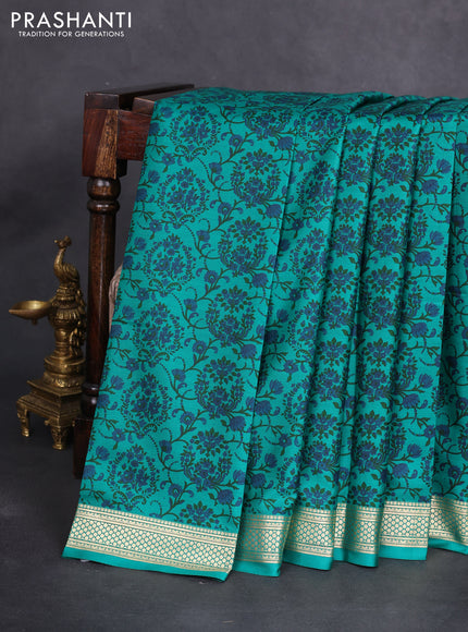 Printed silk saree teal green with allover prints and zari woven border