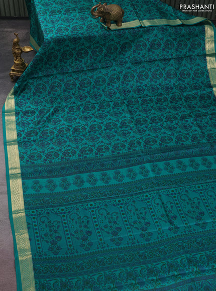 Printed silk saree teal green with allover prints and zari woven border