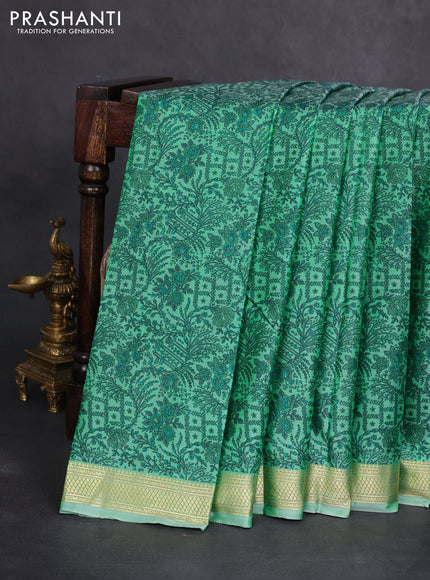 Printed silk saree teal green shade with allover prints and zari woven border