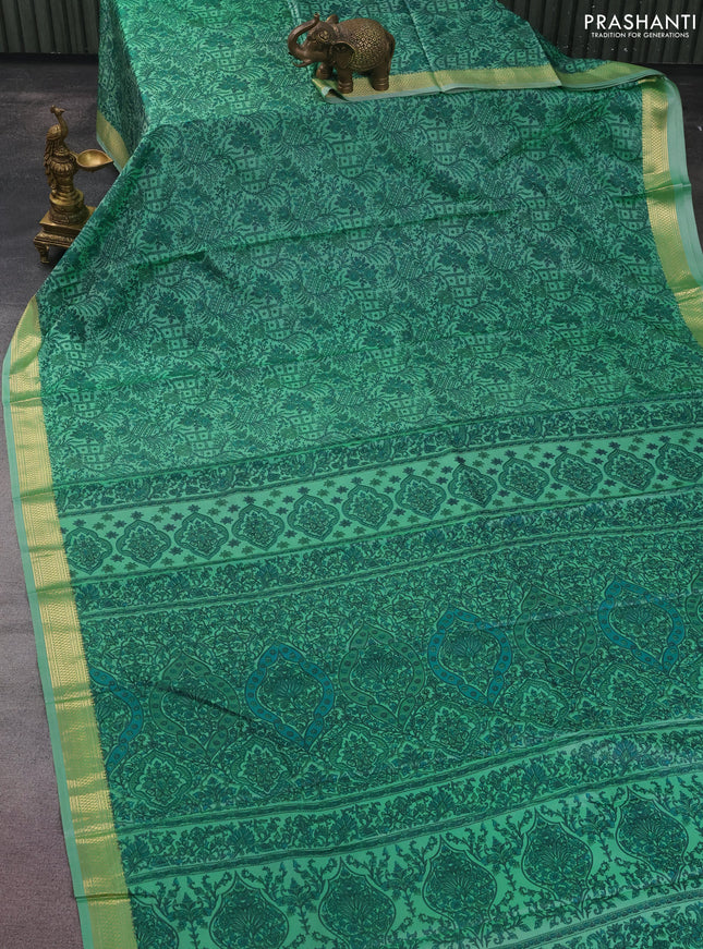 Printed silk saree teal green shade with allover prints and zari woven border