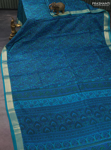 Printed silk saree teal green with allover prints and zari woven border