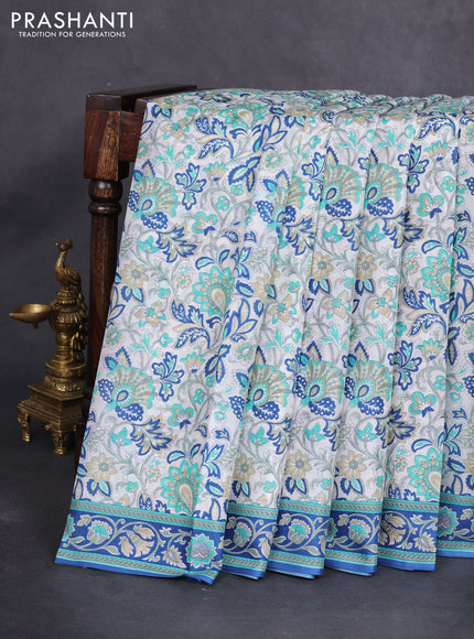 Printed silk saree off white and blue with allover prints and printed border