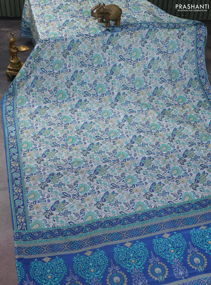 Printed silk saree off white and blue with allover prints and printed border