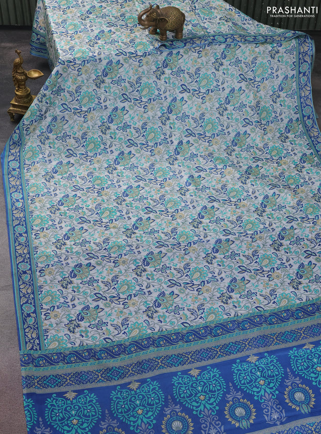 Printed silk saree off white and blue with allover prints and printed border