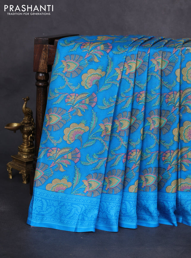 Printed silk saree csblue with allover prints and zari woven border