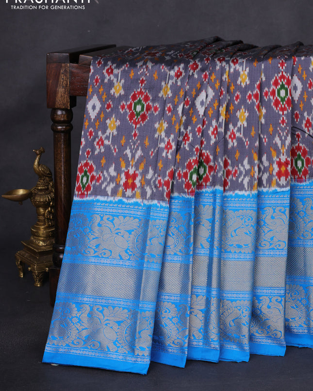 Pochampally silk saree grey and cs blue with allover ikat weaves and long silver & gold zari woven border